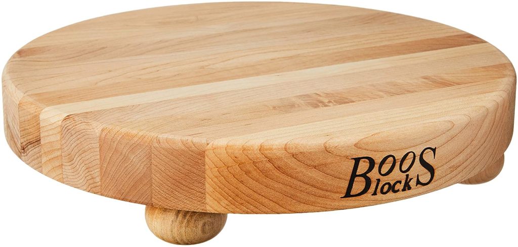 round butcher block cutting board with BOOS brand logo and rounded legs