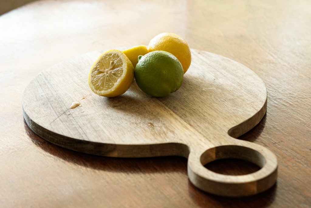 round cutting board with cut citrus