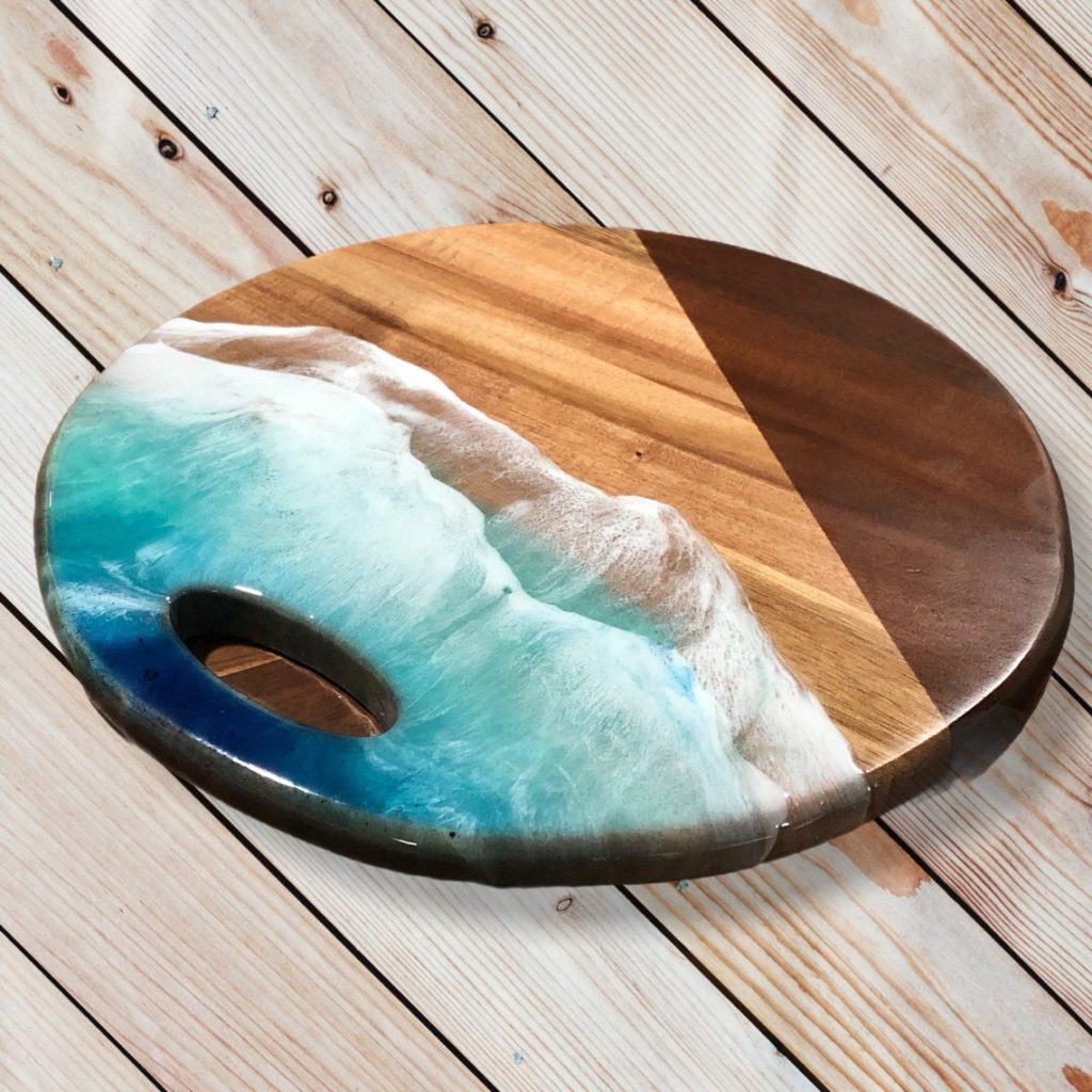 round wooden cutting board with blue resin detail
