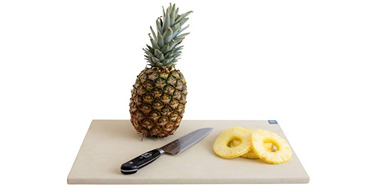 rubber cutting board with pineapple and knife on it