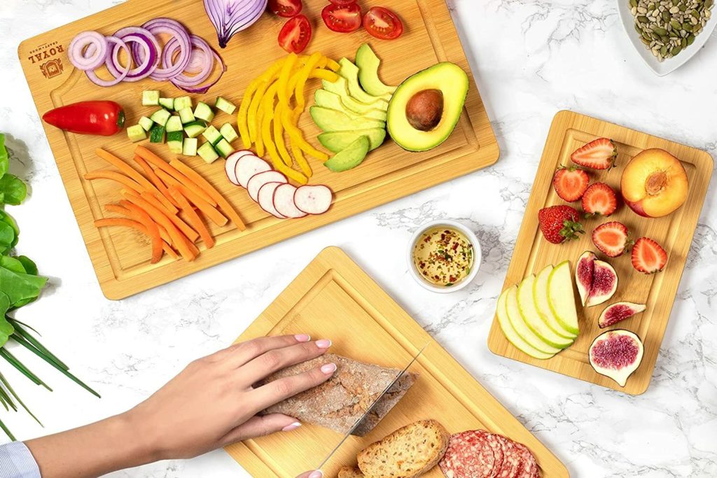 set of three bamboo cutting boards with snacks and foods