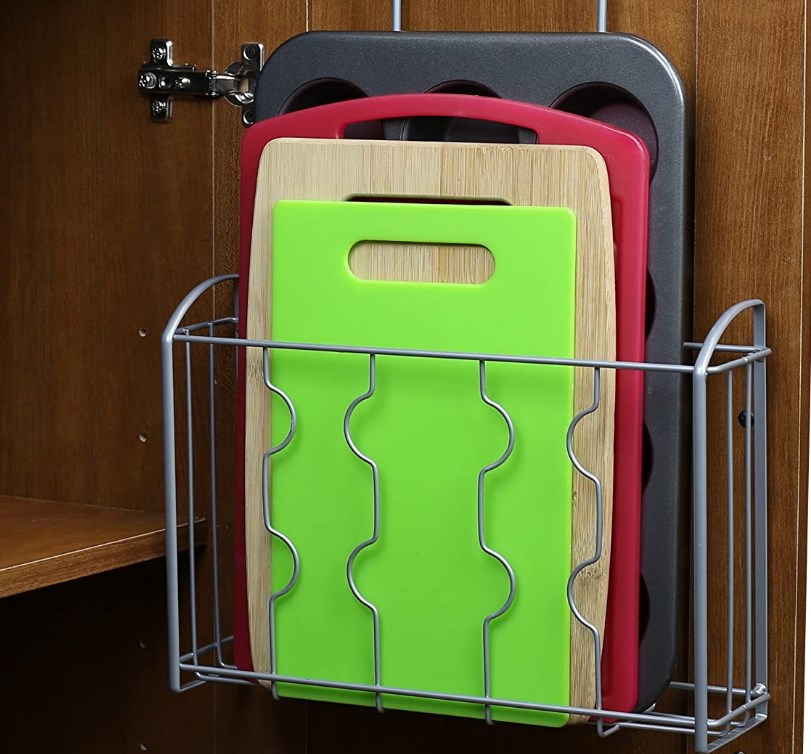 silver metal cutting board storage rack in cabinet