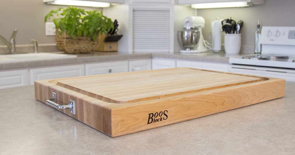 thick wooden cutting board with silver handles