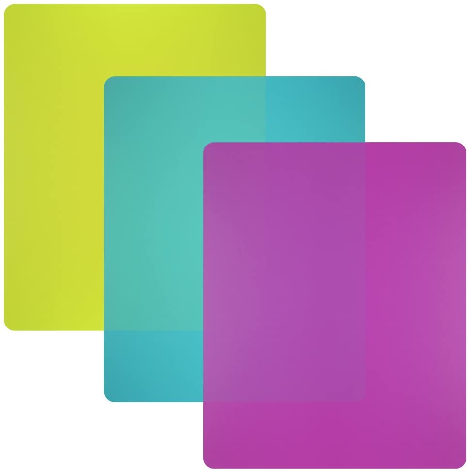 three plastic cutting boards in purple green and yellow