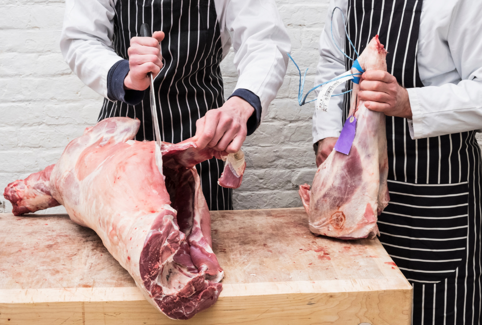 two people butchering meat