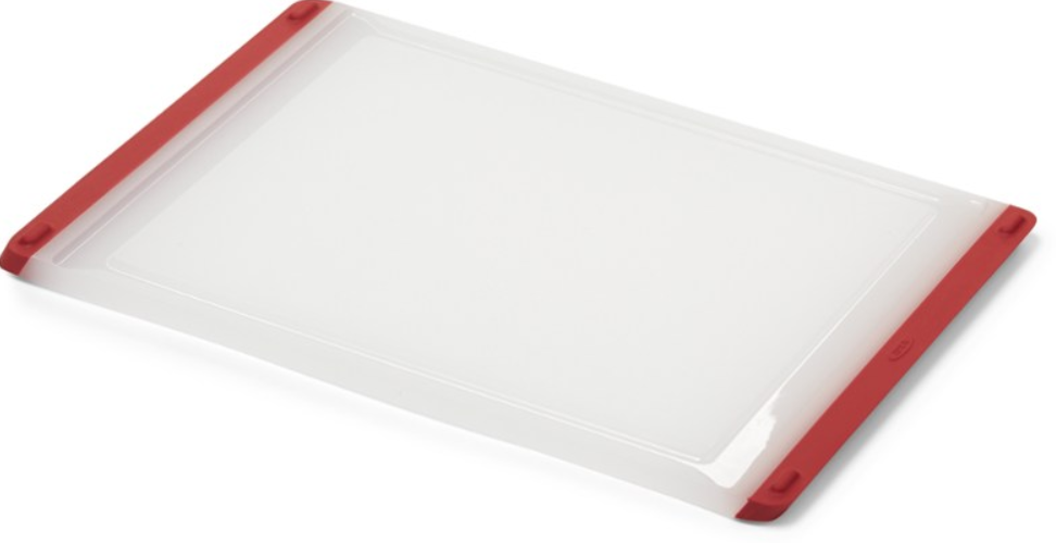 white plastic cutting board with red trim