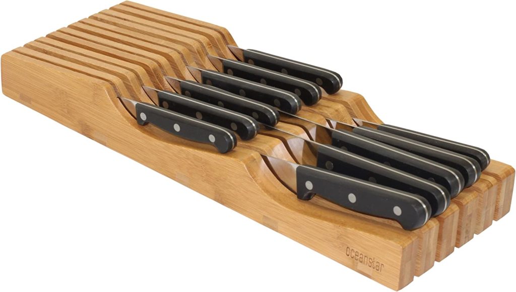 black handled knives stored in bamboo holder
