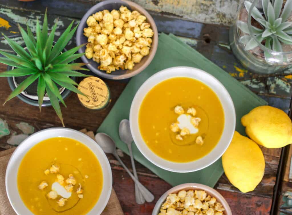 flatlay of orange soup styled in bowls on table