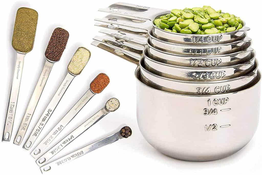 stackable stainless steel measuring cups and spoons filled with seasoning